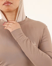 Close-up of soft dry-fit stretch fabric on brown Doe Modest Flow Top