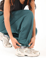 Teal green Doe Cloud Fit Pants on model — relaxed balloon fit